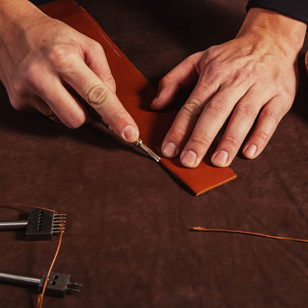 Close-up of leather-working for a brown leather belt.