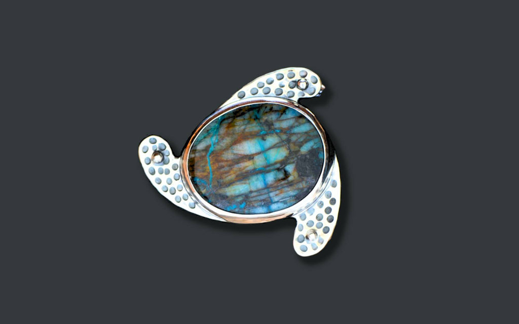 A dramatically-colored, blue stone belt buckle in hand-made sterling silver setting