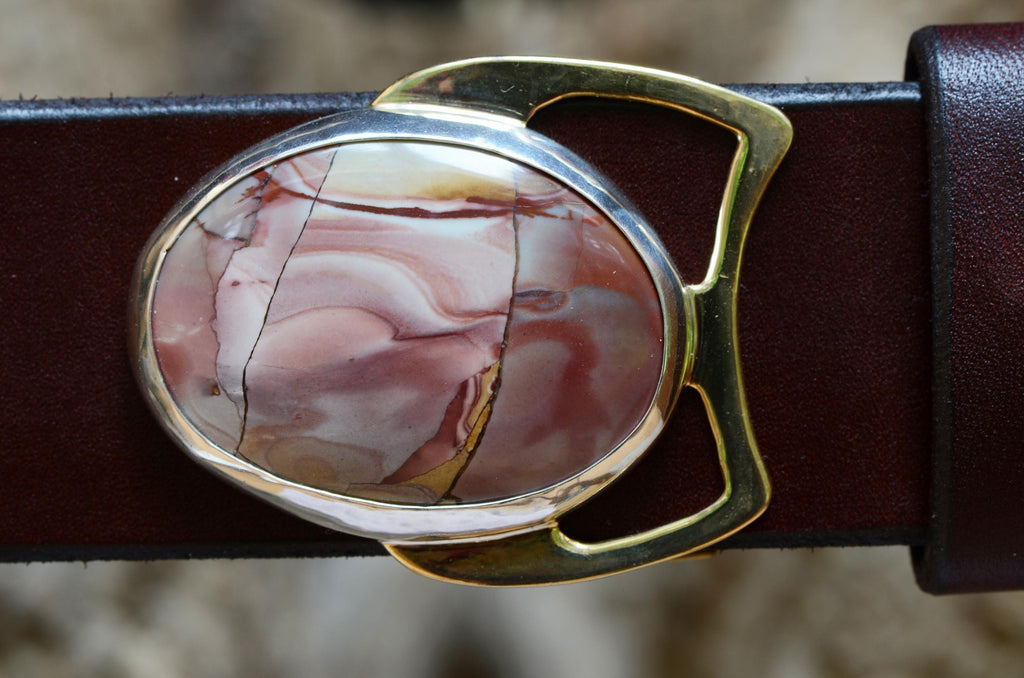 Mescalero jasper cabochon in swirling pinks and golds, set in a bronze belt buckle. Displayed with a brown leather belt.