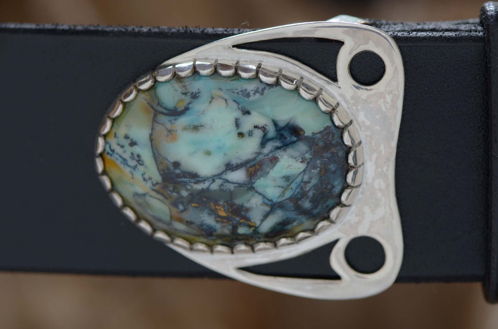 Nicely-figured blue opalwood stone set in a hand-made silver belt buckle. Displayed with black leather belt.